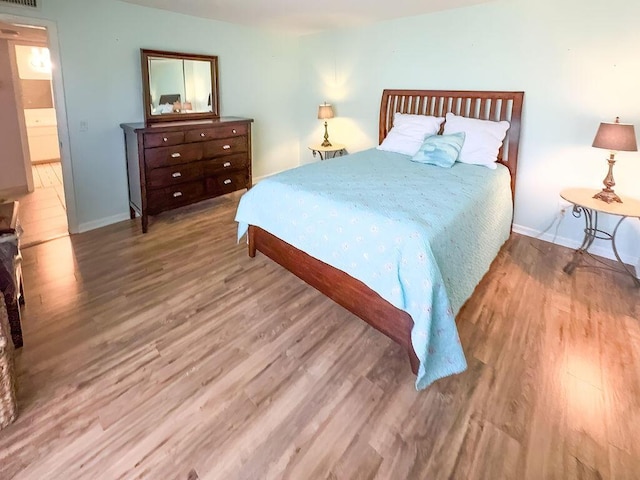 9407 S Ocean Dr Unit 1D, Jensen Beach, FL 34957 - bedroom featuring wood finished floors and baseboards