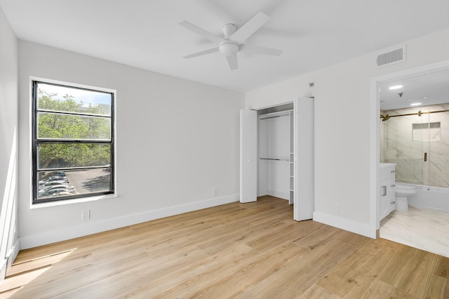 unfurnished bedroom featuring visible vents, baseboards, light wood-style floors, and ensuite bathroom