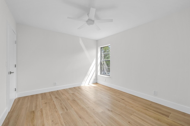 unfurnished room with baseboards, ceiling fan, and light wood finished floors