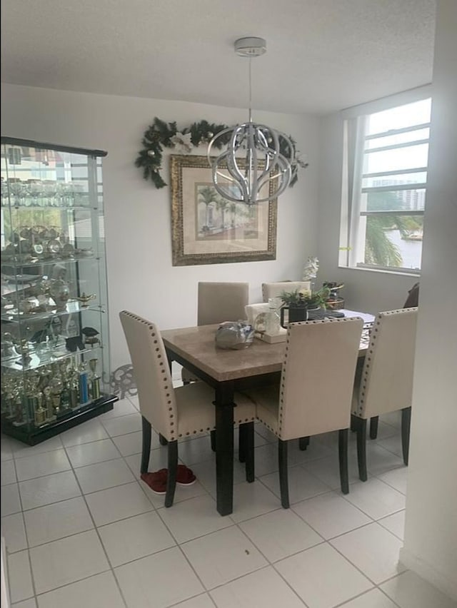 3113 S Ocean Dr Unit 301, Hallandale Beach, FL 33009 - dining room featuring light tile patterned floors and an inviting chandelier