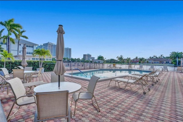 3113 S Ocean Dr Unit 301, Hallandale Beach, FL 33009 - community pool featuring a view of city, fence, and a patio area