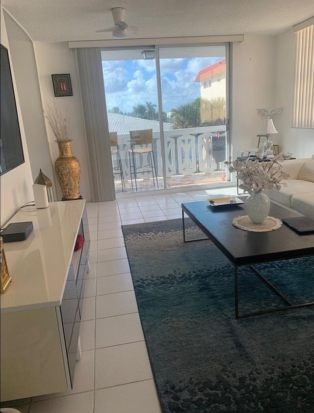 3113 S Ocean Dr Unit 301, Hallandale Beach, FL 33009 - living room featuring light tile patterned flooring, floor to ceiling windows, and a textured ceiling