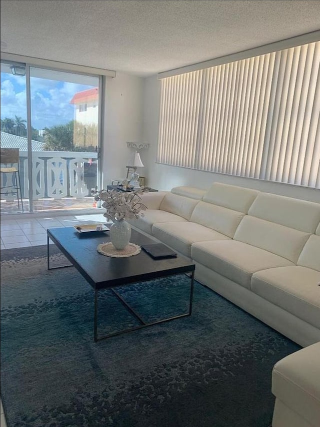 3113 S Ocean Dr Unit 301, Hallandale Beach, FL 33009 - tiled living room with a textured ceiling and expansive windows