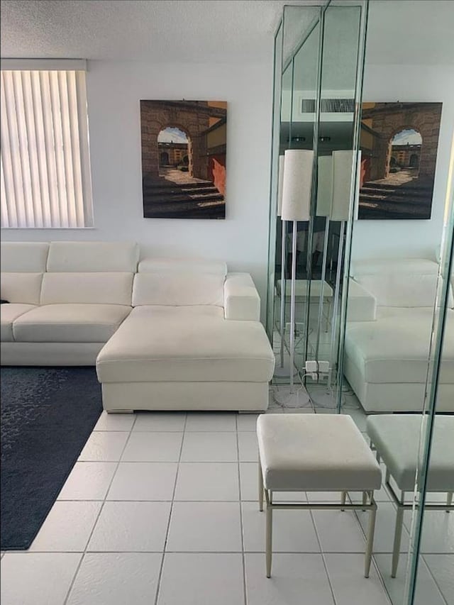 3113 S Ocean Dr Unit 301, Hallandale Beach, FL 33009 - tiled living room with a textured ceiling