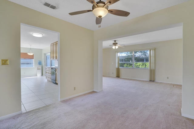 4475 Pine Park Cir, Lake Worth, FL 33467 - spare room featuring light tile patterned floors, a ceiling fan, visible vents, and light carpet