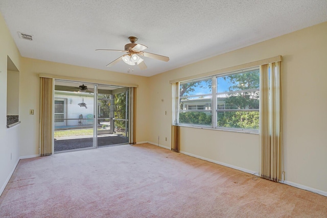 4475 Pine Park Cir, Lake Worth, FL 33467 - spare room featuring a wealth of natural light, carpet floors, a textured ceiling, and a ceiling fan