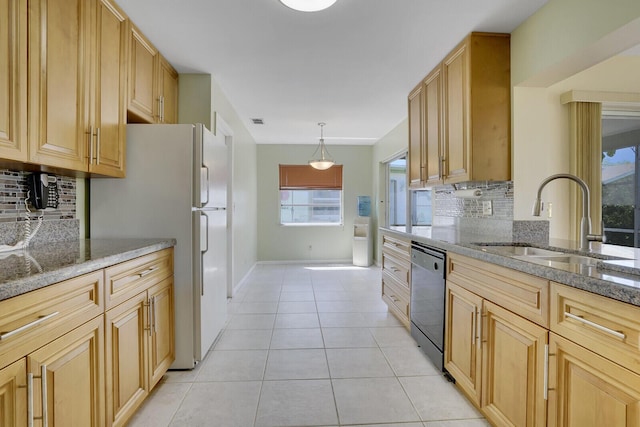 4475 Pine Park Cir, Lake Worth, FL 33467 - kitchen featuring dishwashing machine, light stone counters, light tile patterned flooring, a sink, and backsplash