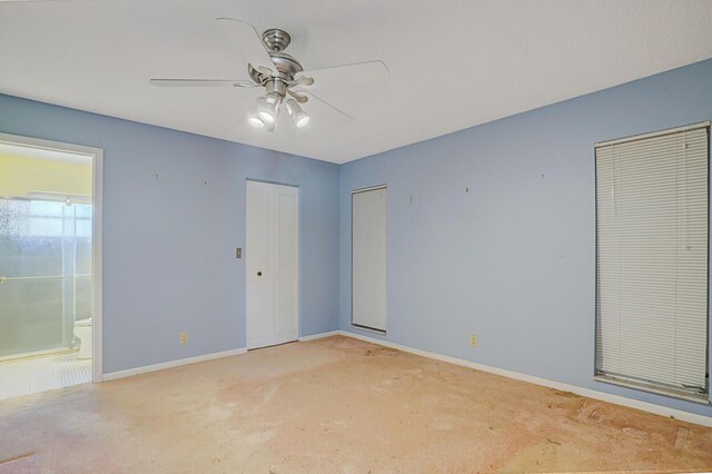 4475 Pine Park Cir, Lake Worth, FL 33467 - unfurnished bedroom featuring baseboards, light colored carpet, ensuite bath, and a ceiling fan