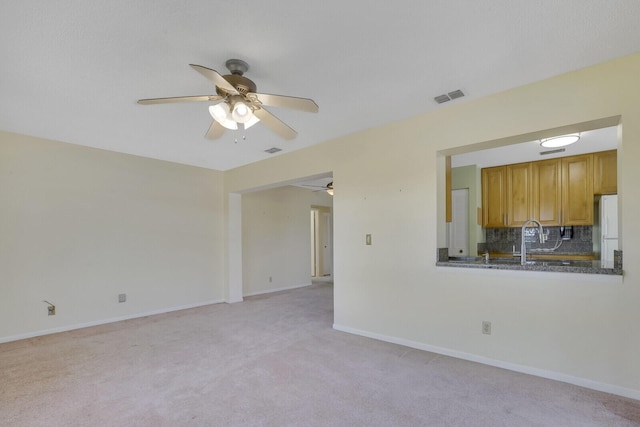 4475 Pine Park Cir, Lake Worth, FL 33467 - unfurnished living room featuring visible vents, light colored carpet, baseboards, and ceiling fan