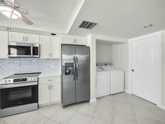 3642 SW Sunset Trace Cir, Palm City, FL 34990 - kitchen featuring visible vents, appliances with stainless steel finishes, white cabinets, and washing machine and clothes dryer