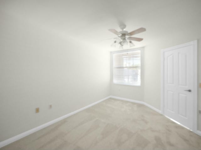 3642 SW Sunset Trace Cir, Palm City, FL 34990 - spare room featuring baseboards, light colored carpet, and ceiling fan