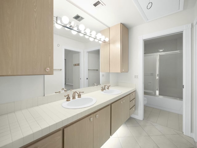 3642 SW Sunset Trace Cir, Palm City, FL 34990 - full bath featuring a sink, visible vents, toilet, and tile patterned floors