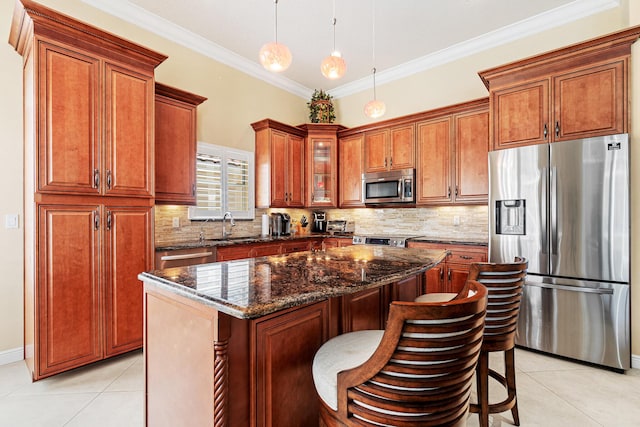 kitchen with decorative backsplash, crown molding, light tile patterned floors, and stainless steel appliances