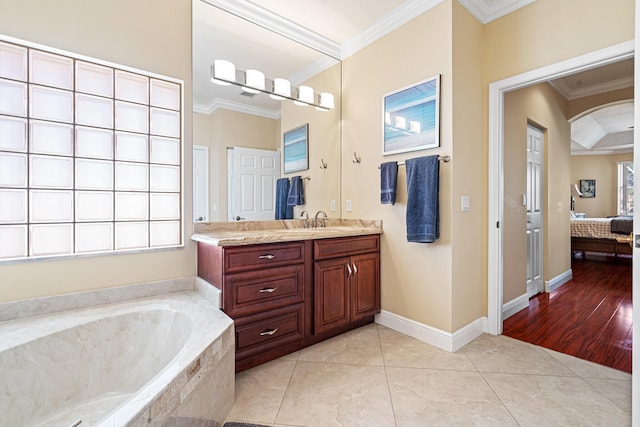 ensuite bathroom with tile patterned flooring, vanity, crown molding, and a garden tub