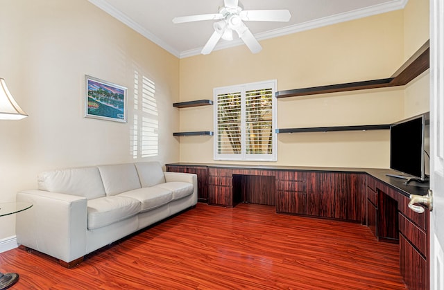 unfurnished office with wood finished floors, a ceiling fan, and ornamental molding