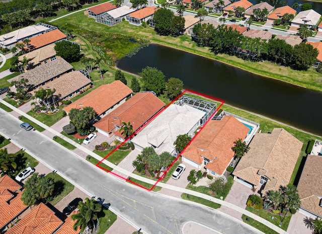 drone / aerial view featuring a residential view and a water view