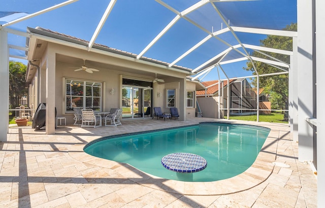 pool featuring a lanai, ceiling fan, and a patio