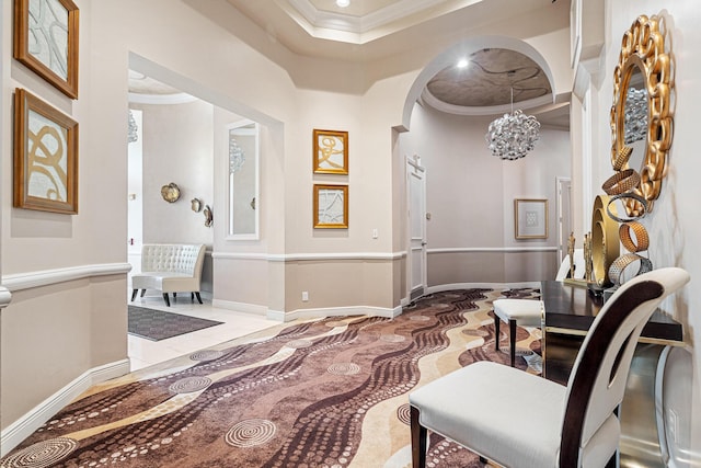 interior space featuring baseboards, recessed lighting, arched walkways, crown molding, and a notable chandelier