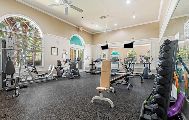 workout area featuring a wealth of natural light, visible vents, crown molding, and ceiling fan
