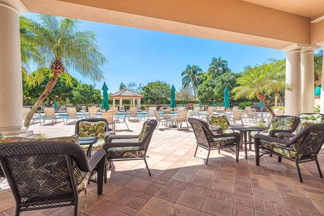 view of patio / terrace featuring a community pool and fence