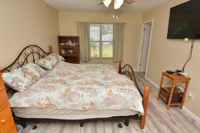 557 SE Seahouse Dr, Port Saint Lucie, FL 34983 - bedroom with light wood finished floors, baseboards, and ceiling fan
