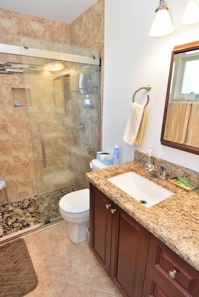 557 SE Seahouse Dr, Port Saint Lucie, FL 34983 - bathroom featuring a tile shower, vanity, and toilet