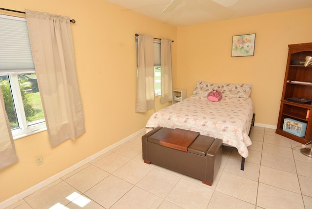 557 SE Seahouse Dr, Port Saint Lucie, FL 34983 - bedroom featuring tile patterned floors, ceiling fan, and baseboards