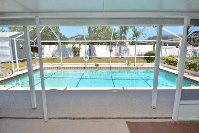 557 SE Seahouse Dr, Port Saint Lucie, FL 34983 - view of swimming pool featuring a fenced in pool, fence, and glass enclosure