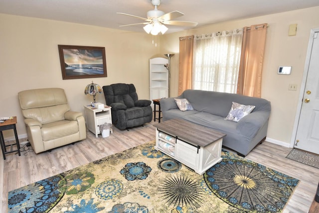 557 SE Seahouse Dr, Port Saint Lucie, FL 34983 - living area with baseboards, a ceiling fan, and wood finished floors