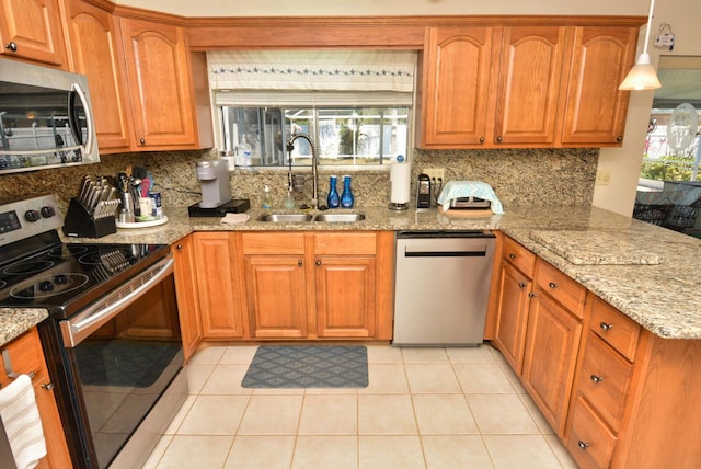 557 SE Seahouse Dr, Port Saint Lucie, FL 34983 - kitchen with a sink, backsplash, light stone counters, and stainless steel appliances