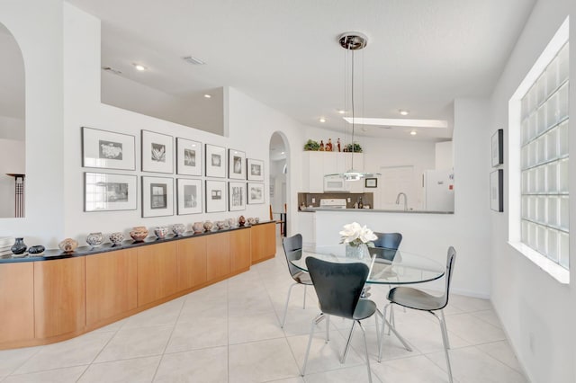 12792 Coral Lakes Dr, Boynton Beach, FL 33437 - dining room with arched walkways, light tile patterned flooring, and recessed lighting