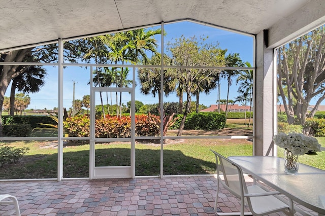 12792 Coral Lakes Dr, Boynton Beach, FL 33437 - unfurnished sunroom with lofted ceiling and outdoor dining area