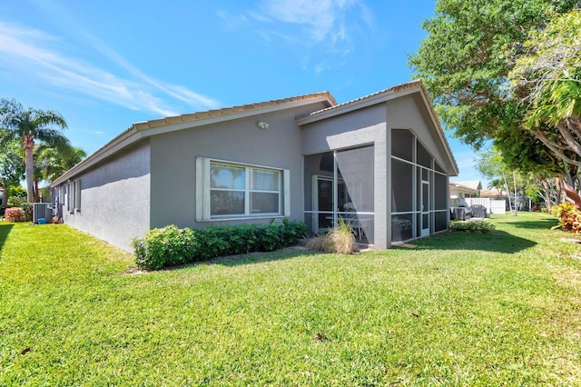 12792 Coral Lakes Dr, Boynton Beach, FL 33437 - rear view of property with stucco siding, a lawn, a sunroom, and central air condition unit
