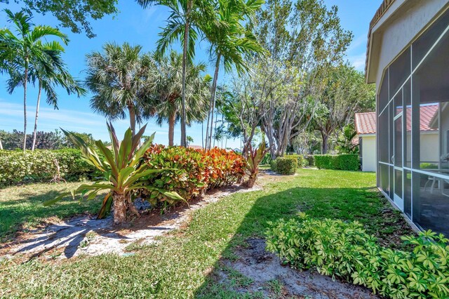 12792 Coral Lakes Dr, Boynton Beach, FL 33437 - view of grassy yard with glass enclosure
