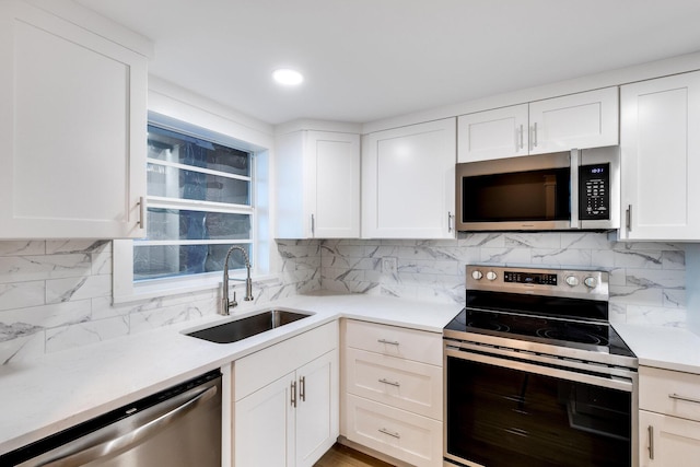 308 Golfview Rd Unit Ph02, North Palm Beach, FL 33408 - kitchen with light countertops, backsplash, a sink, stainless steel appliances, and white cabinets