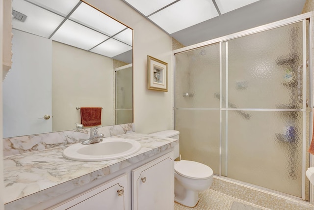 bathroom featuring a stall shower, visible vents, toilet, and vanity