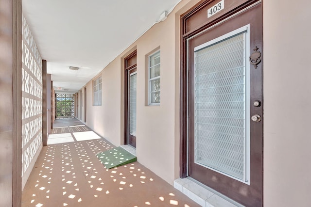 property entrance with stucco siding
