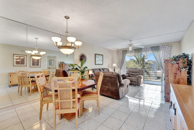 dining space featuring a textured ceiling, light tile patterned floors, and ceiling fan with notable chandelier