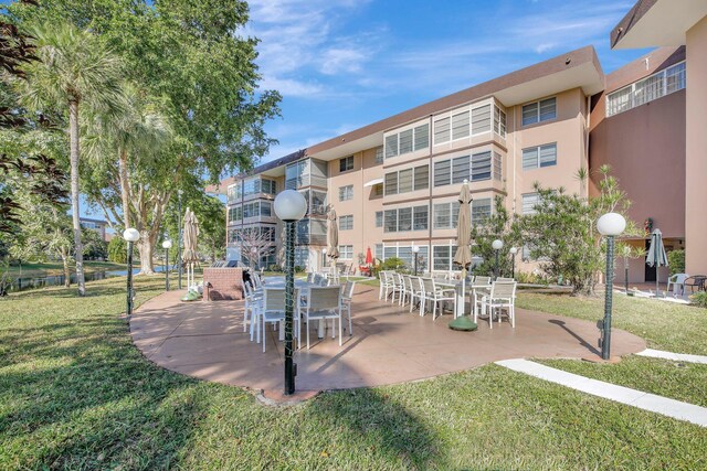 view of home's community featuring a patio area and a yard