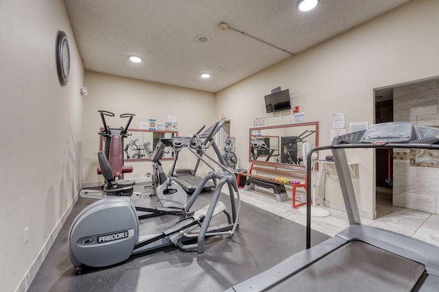 workout area featuring baseboards and recessed lighting