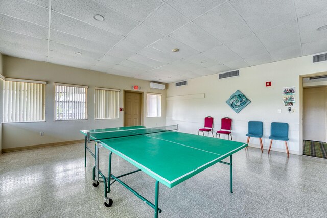 game room featuring a paneled ceiling, speckled floor, baseboards, and visible vents