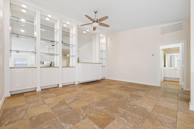 spare room with visible vents, stone tile floors, baseboards, ceiling fan, and recessed lighting