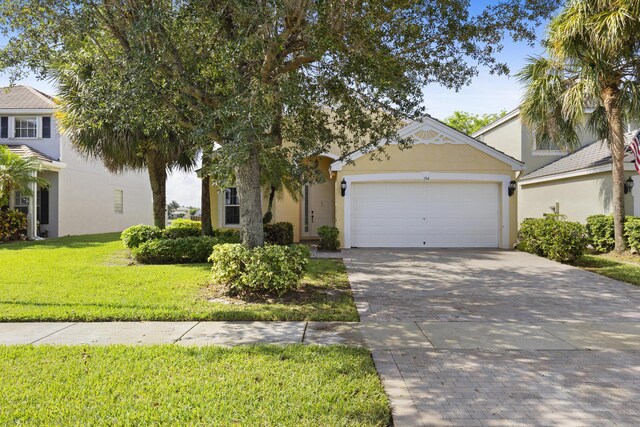154 Berenger Walk, Royal Palm Beach, FL 33414 - view of front facade featuring an attached garage, driveway, stucco siding, and a front lawn