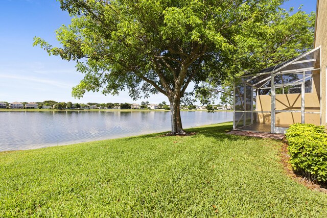 154 Berenger Walk, Royal Palm Beach, FL 33414 - view of green lawn featuring a water view and glass enclosure