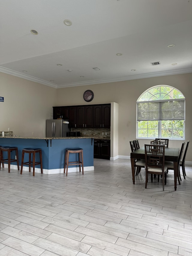 154 Berenger Walk, Royal Palm Beach, FL 33414 - dining area featuring crown molding, baseboards, light wood finished floors, and recessed lighting