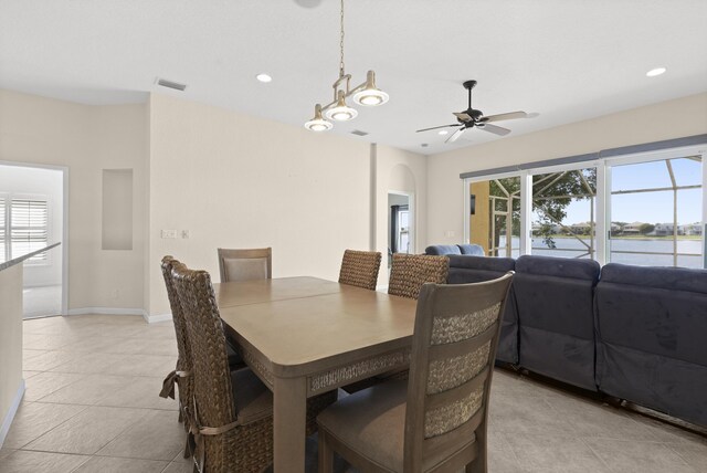 154 Berenger Walk, Royal Palm Beach, FL 33414 - dining room featuring light tile patterned floors, ceiling fan, a water view, arched walkways, and recessed lighting
