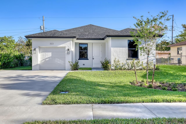 311 Ocean Pkwy, Boynton Beach, FL 33435 - ranch-style house with a front lawn, fence, stucco siding, a garage, and driveway