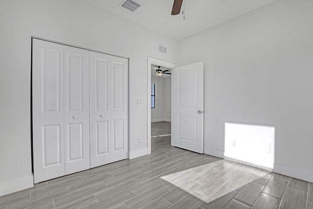 311 Ocean Pkwy, Boynton Beach, FL 33435 - unfurnished bedroom with a closet, visible vents, baseboards, and wood tiled floor