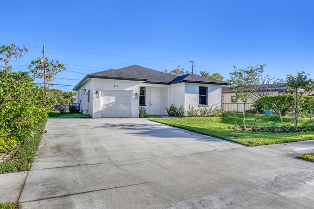 311 Ocean Pkwy, Boynton Beach, FL 33435 - ranch-style house featuring stucco siding, driveway, an attached garage, and a front yard
