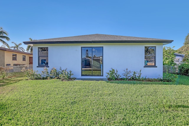 311 Ocean Pkwy, Boynton Beach, FL 33435 - rear view of house featuring stucco siding, a yard, and fence